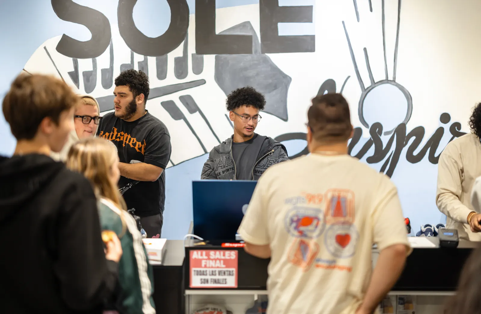 Soleinspires staff helping customers at the counter